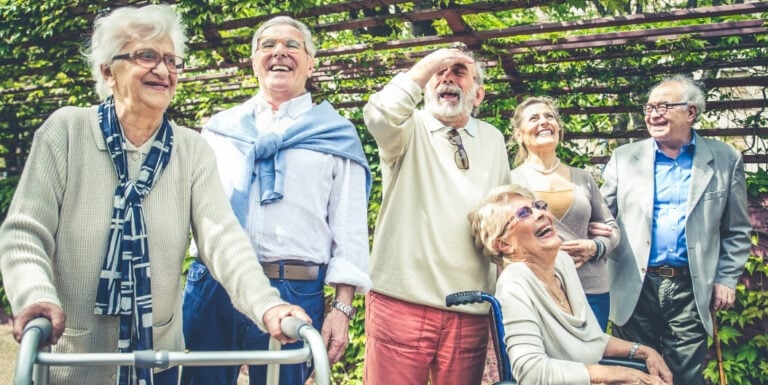 Group of Elderly Residents Socializing Outdoors at a Memory Care Facility