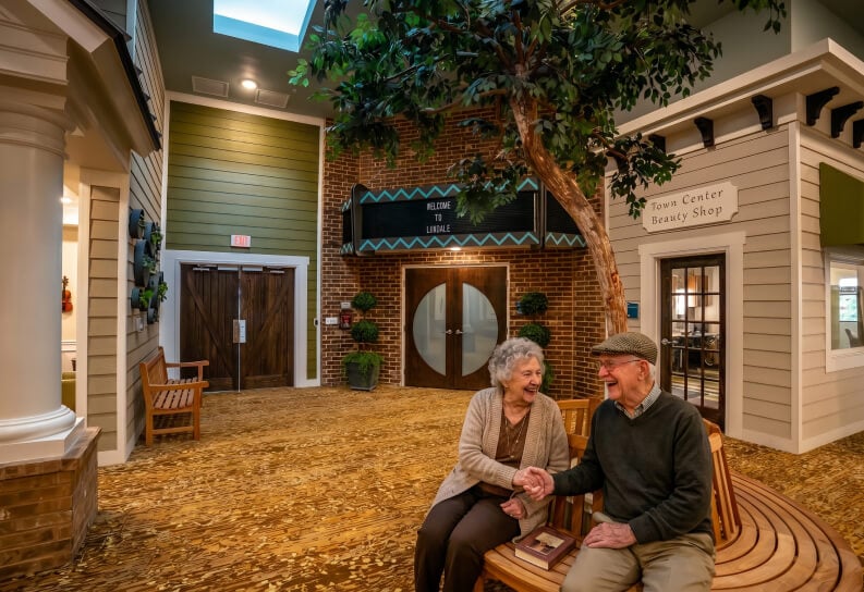 Elderly Couple Relaxing on a Bench at a Memory Care Facility Elderly Couple Relaxing on a Bench at a Memory Care Facility